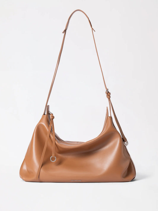 A round soft split cowhide leather hobo bag in a warm tan tone with a slouchy donut-inspired silhouette