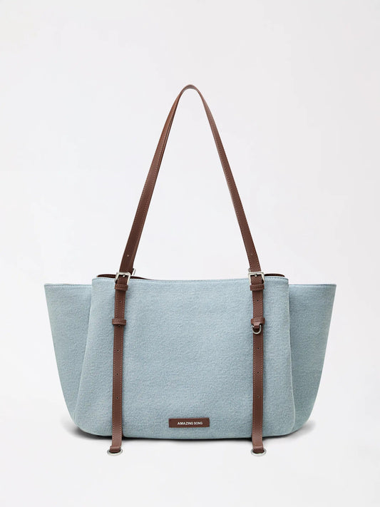 Round donut-inspired denim and canvas tote bag in blue with a playful top handle