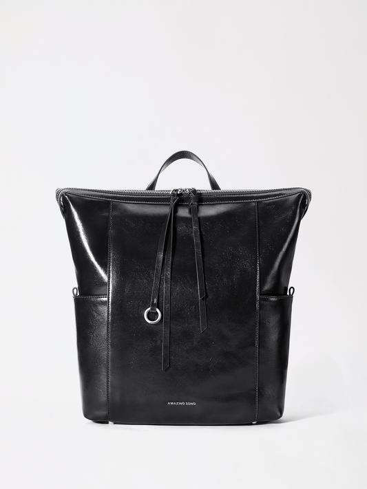 A structured donut-inspired leather backpack in warm tan leather