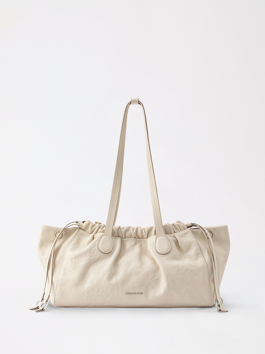 A soft cloud hobo leather shoulder bag with a gently rounded silhouette in warm tan tone