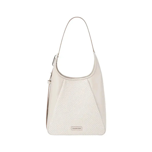 A large flat bucket bag in warm tan top-grain leather standing upright with soft rounded silhouette
