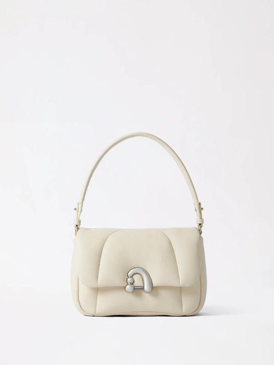 plump rounded beige bag with a soft matte finish and gentle bun-like silhouette