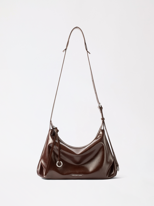 Small donut-shaped top-grain leather hobo bag in warm tan with a soft slouchy body