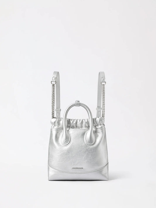 A small slouchy hobo-style bag with slim backpack straps, worn close to the back