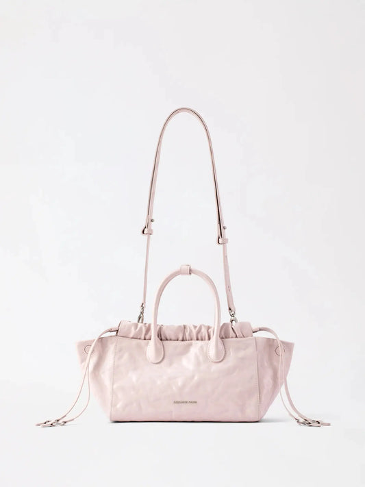 A soft cloud-shaped small crossbody hobo bag in cowgrain leather with a relaxed, slouchy finish