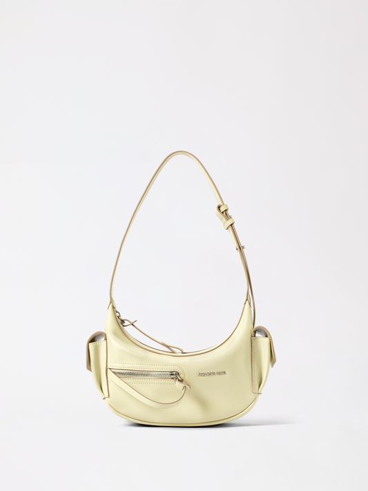 Small crescent leather purse in warm tan, shaped like a rolled pastry