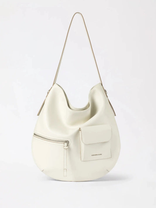 a slouchy rounded hobo bag in a warm amber-brown tone with a soft matte finish