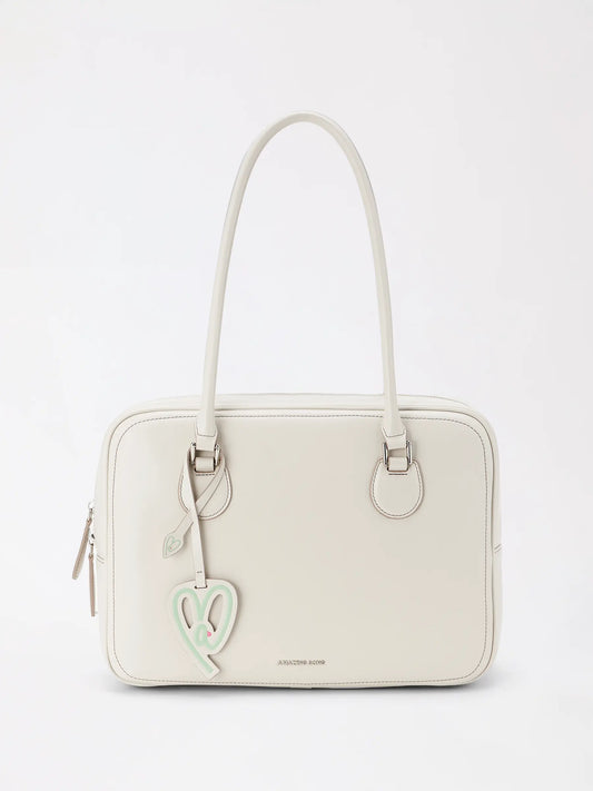 A large toast-shaped top-grain leather bag in warm tan leather