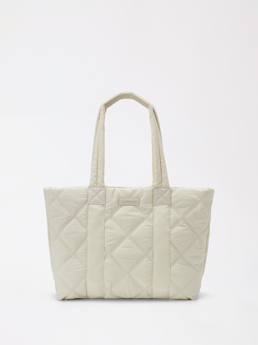 Down Tote bakery-inspired genuine leather bag in warm tan resting on a table