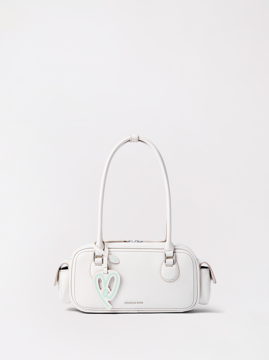 A long tan leather baguette bag shaped like a fresh loaf of bread