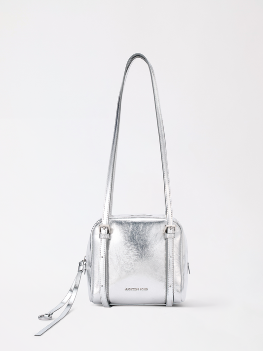 Square donut-shaped top-grain leather bag with soft rounded corners in warm tan
