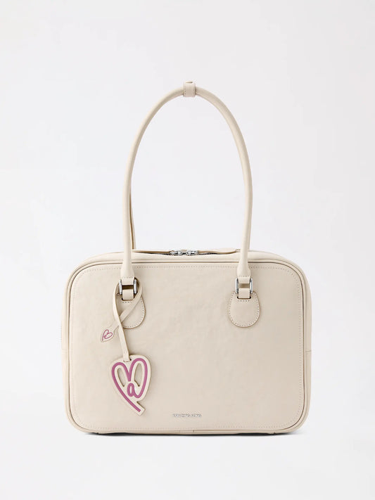 A large top-grain genuine leather toast-inspired bag showing the smooth, cleanable surface that rewards simple, regular care